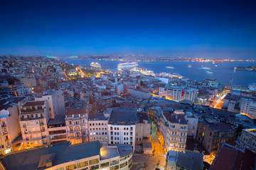 Long exposure cityscape of Istanbul at a night from Galata to the Bosphorus. Wonderful romantic old town at Sea of Marmara. Bright light of street lighting and cruise liners. Istanbul. Turkey.