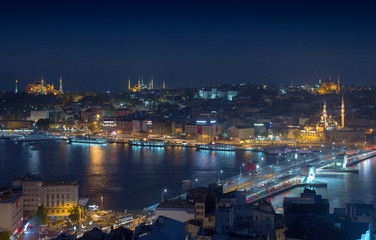 Long exposure cityscape of Istanbul at a night. Galata bridge on Golden Horn gulf. Wonderful romantic old town at Sea of Marmara. Bright light of street lighting and various ships. Istanbul. Turkey.