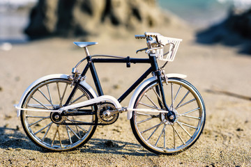 Fototapeta na wymiar Daylight view to handicraft bicycle souvenir on sand