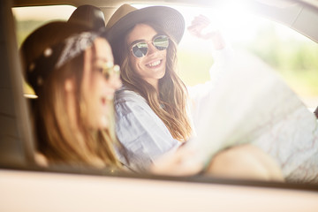 Two young women having fun driving