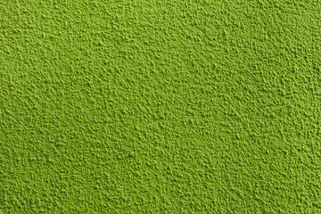 Green painted stucco wall.