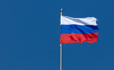Flag of the Russian Federation against the blue sky