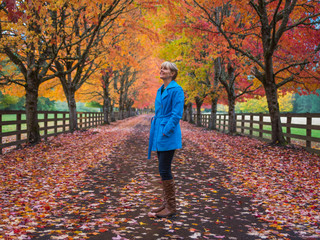 Woman enjoying fall colors along road