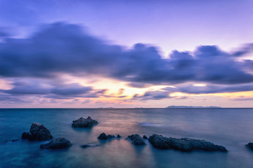 Fototapeta na wymiar Tropical sunset on the stones beach. Koh Lan island. Thailand