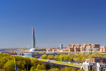 View from height of Ferris wheel to amusement Park and Glass 462-meter skyscraper Lakhta Center....