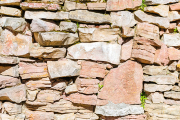 Stone texture of limestone wall for creative background. Light limestone stones joined with cement in a single stone panel. Landscape architecture in park. Saint-Petersburg, Russia