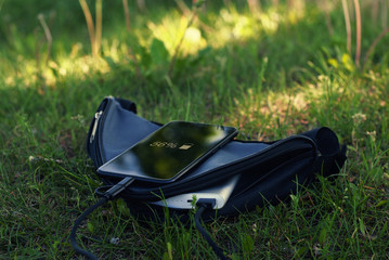 A portable charger charges the smartphone. Power Bank with cable in the case
