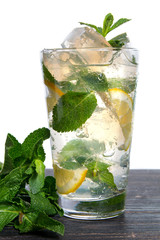 Cocktail with lime, mint and crushed ice isolated on a white background