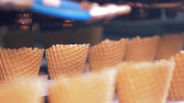 Close up of rows of wafer cones consequently moving
