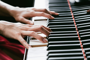 Fototapeta na wymiar Close up of woman hands playing and practicing piano