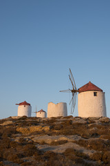 Fototapeta na wymiar A series of deserted windmills at the top of Chora of Amorgos