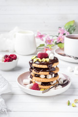 A sweet dessert of a chocolate cookie raspberry and marshmallow