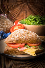 Triangular sandwich with cheese, ham and tomato.