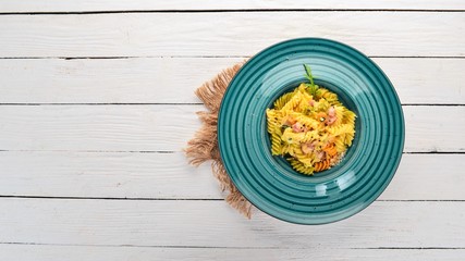 Carbonara Pasta with Bacon. On a wooden background. Italian cuisine. Top view. Copy space.