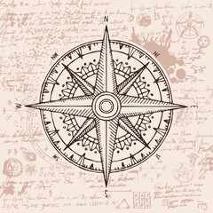 Hand-drawn vector banner with a wind rose and old nautical compass in retro style. Illustration on the theme of travel and discovery on the background of old manuscript