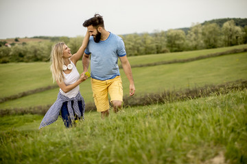 Couple enjoying a walk through grass land