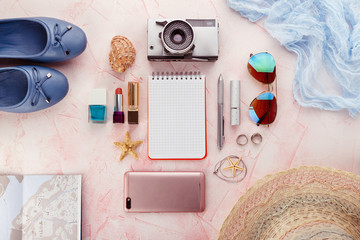 Outfit and accessories of traveler on pink background with copy space, Travel concept.