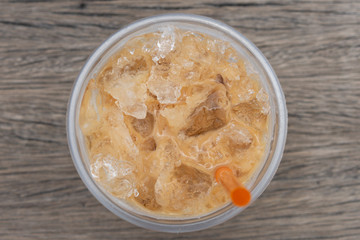 Coffee cool moment the sun is low. On a wooden chair in the park