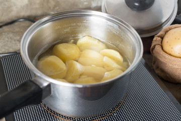 Boiled potato in pot.