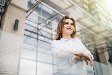 Young Woman on the balcony enjoying city view