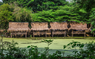 Nipa bamboo Huts at the White Sand beach with palm trees