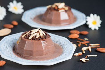 Chocolate pudding topping of chocolate and almond sliced.