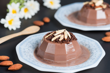 Chocolate pudding topping of chocolate and almond sliced.