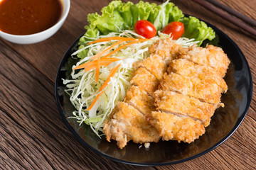 Crispy fried pork cutlet with sauce.