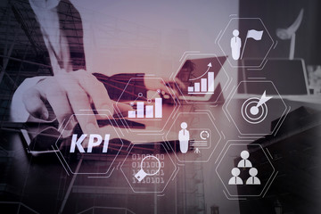 businessman working with smart phone and digital tablet and laptop computer in modern office with London city exposure