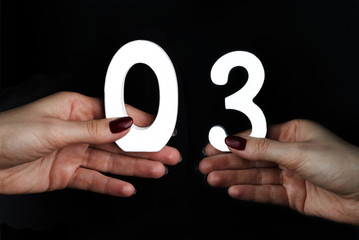 On the palms of the figure three and zero.