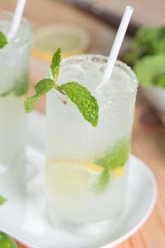 Cold refreshing summer lemonade mojito with fresh lemon and mint leaf.