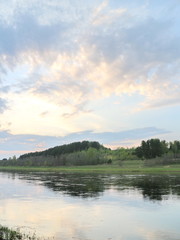 the banks of the spring river in the evening at sunset