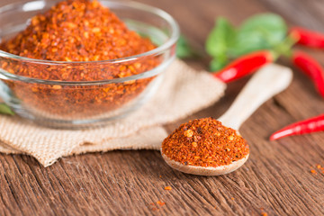 Chili powder on wooden background.
