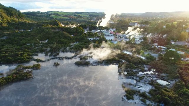 Aerial view of thermal spa Rotorua, smoke and steam from geothermal springs and geysers - North Island, New Zealand from above, 4k UHD