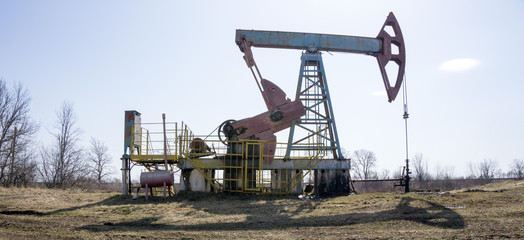 Fototapeta na wymiar Oil pump machine over the blue sky