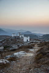 A road leading to a series of deserted windmills at the top of Chora of Amorgos