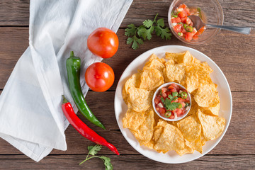 Corn tortilla chips with tomato salsa.