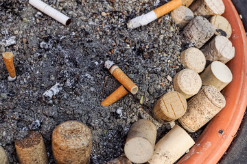 Many Cigarette butts in the dirty ashtray. A lot of Cigarette butts. Reason of lung cancer. Lots of used cigarette butts as litter.