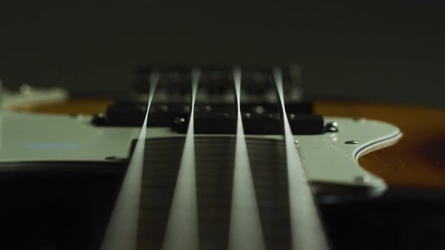 Strings and the fretboard of an electric guitar