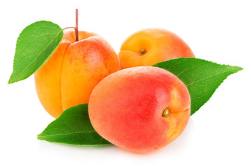 Fresh apricots with leaves close-up isolated on a white background.