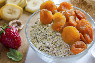 healthy delicious breakfast of oatmeal with dried apricots and fruits