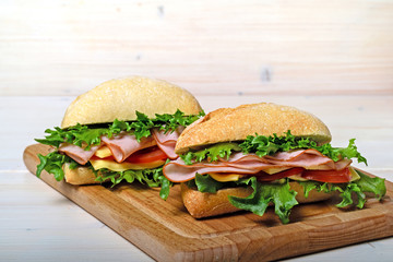 Two frash sandwiches with ham and vegetables