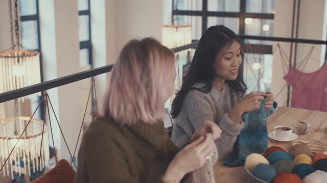 Young women in a knitting lesson