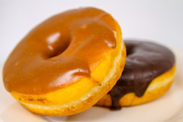 A Maple and Chocolate Doughnut Close-up and Isolated.