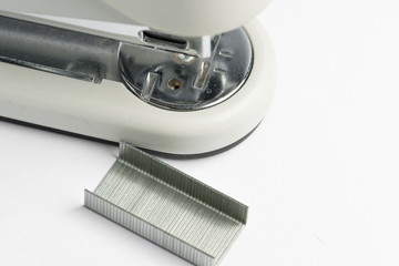 stapler with wire staples on white background