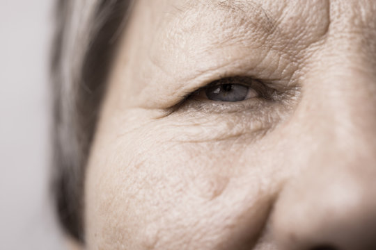 Elderly pensioner female half face portrait closeup