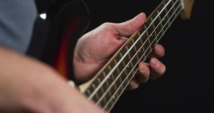 Playing on the fretboard of a bass guitar