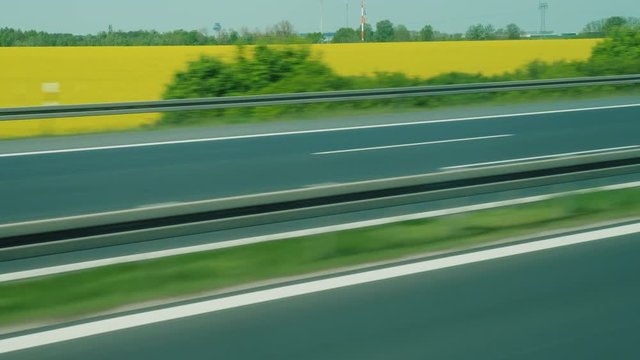 Expressway in Germany, behind the expensive field of yellow rape - raw materials for biofuel