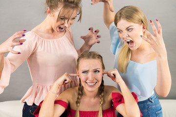 Woman being bullied by two females