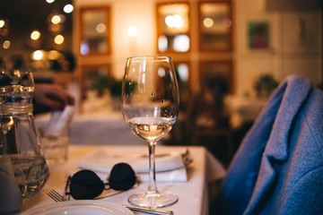 glass in the evening on the table in the restaurant. concept of a lonely date.